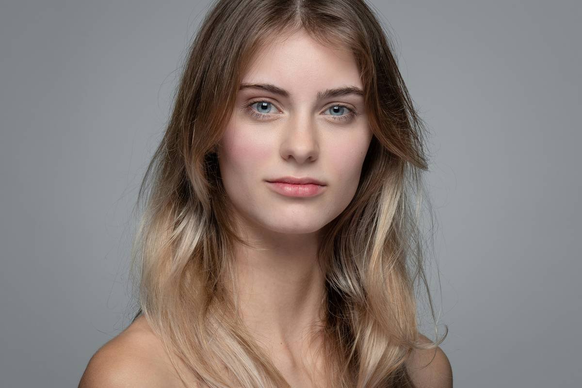 Infographic showing how balayage color fades unevenly from ends upward due to porosity and UV exposure