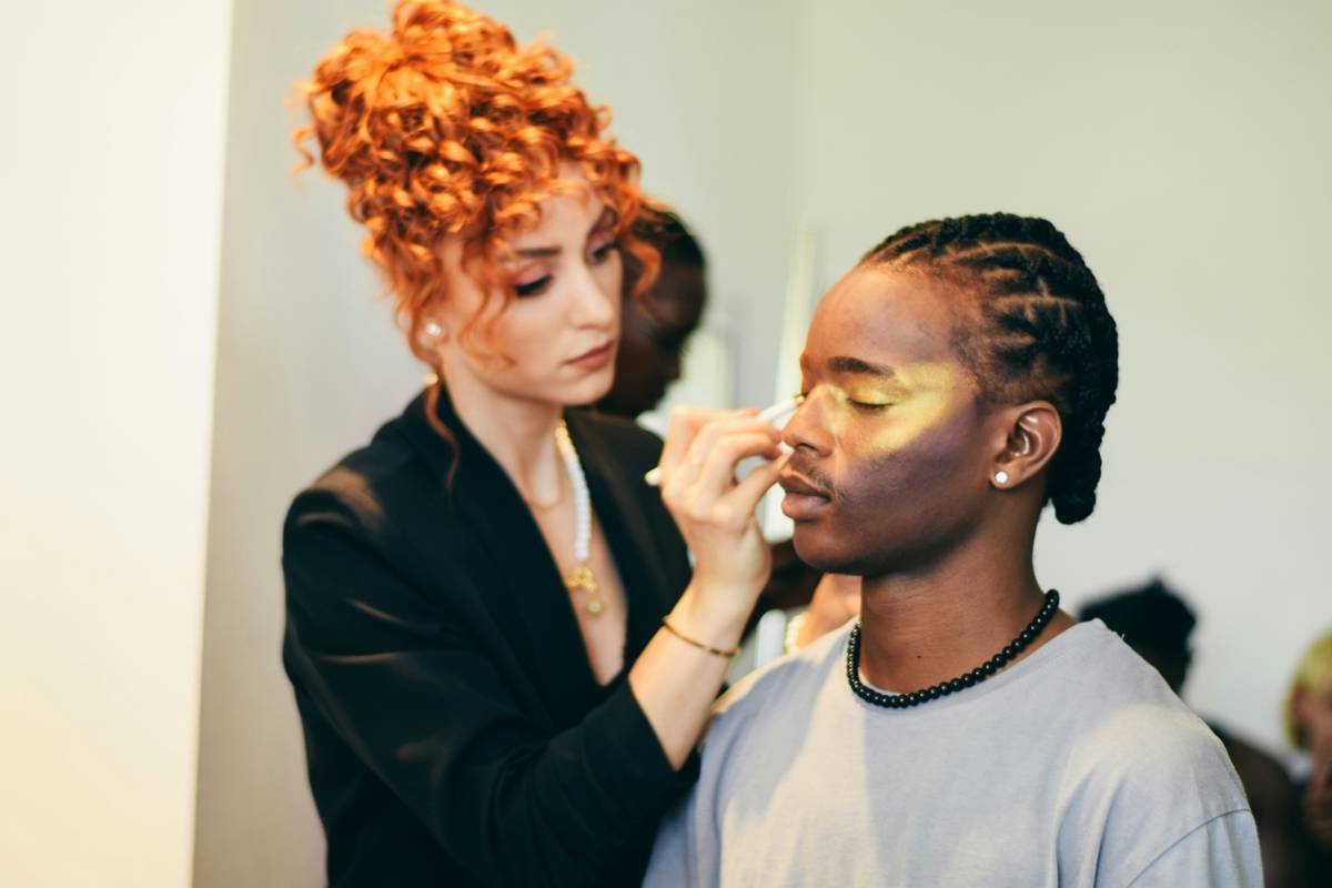 Client admiring finished balayage results in mirror during professional balayage salon experience