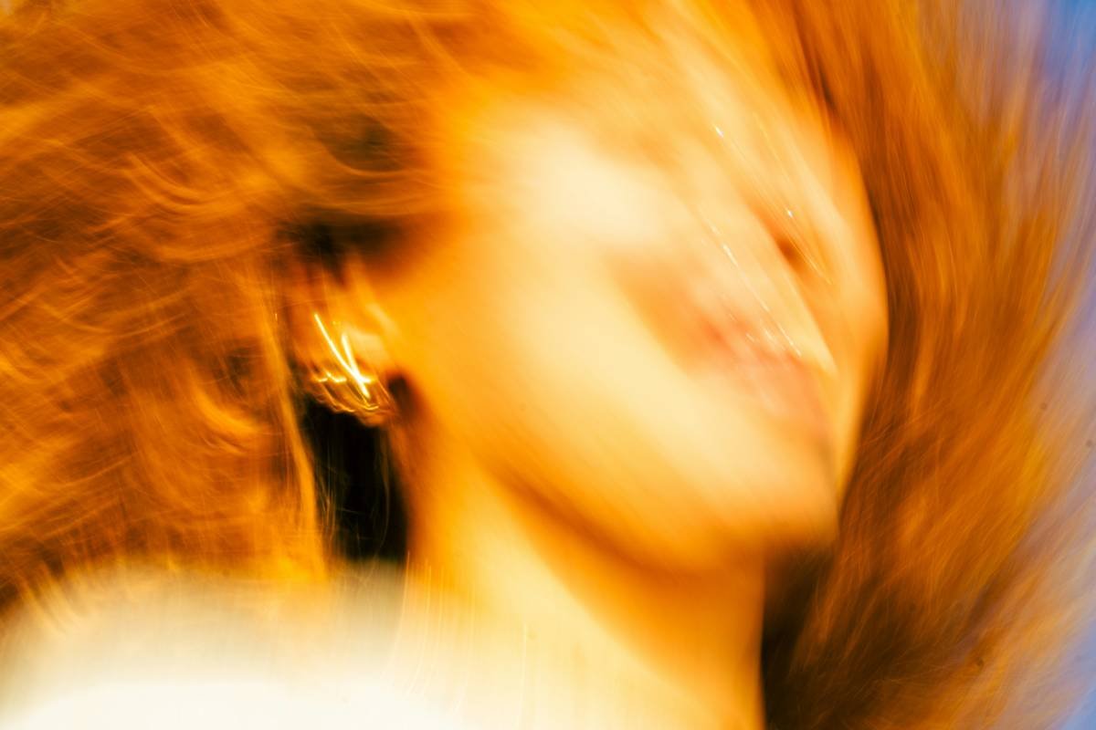 Close-up of healthy, sun-kissed balayage hair vibrance with golden-caramel highlights blending seamlessly into brunette base